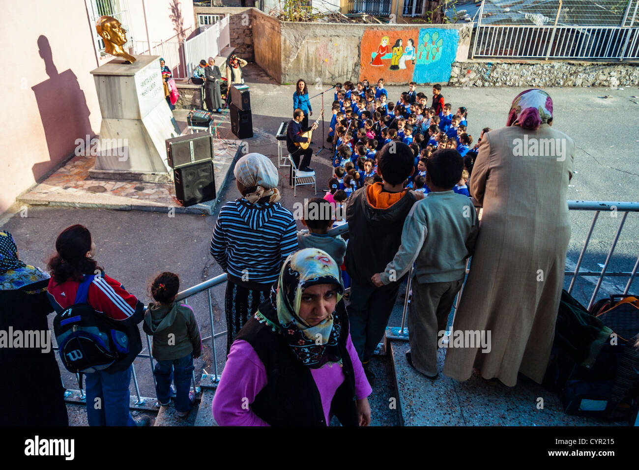 Pupils and teacher singing songs in Turkish schoolyard with huge bust ...