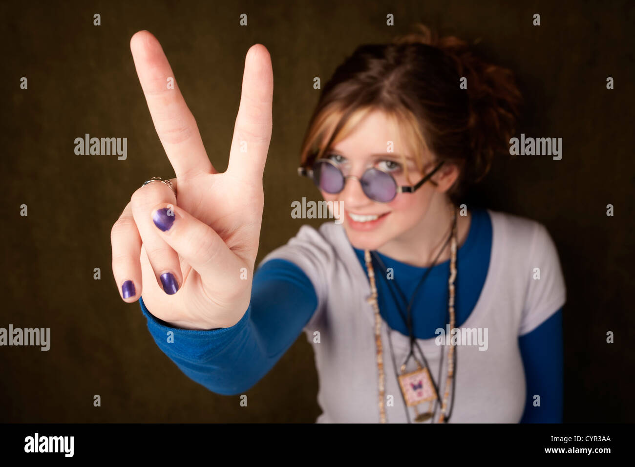 Pretty teen girl making a peace sign with her hand Stock Photo