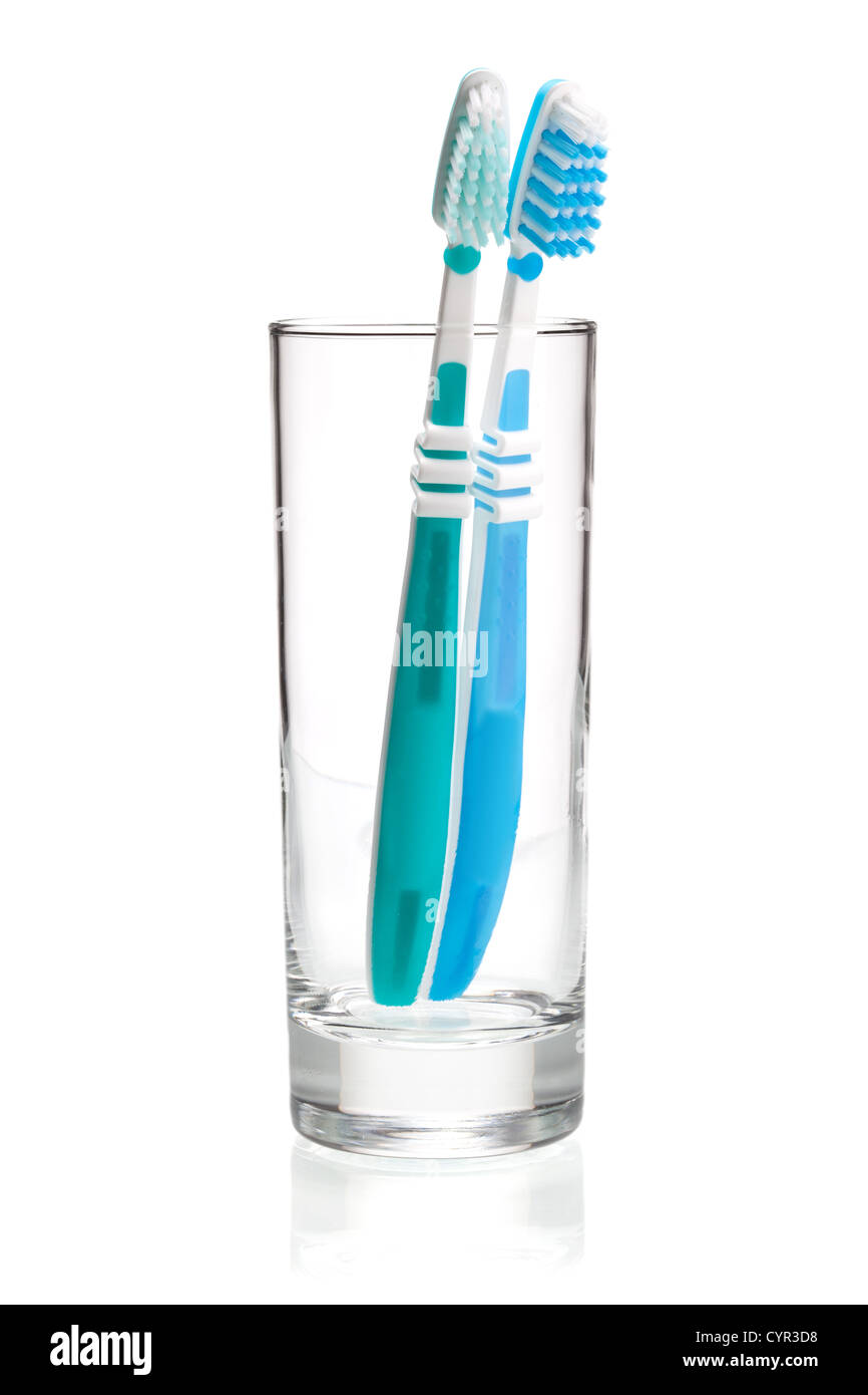 Two tooth brushes in glass. Isolated on white background Stock Photo ...