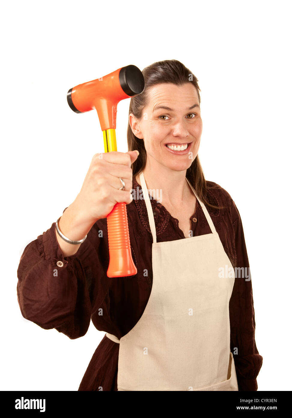 Pretty woman with shop apron and hammer held aloft Stock Photo Alamy