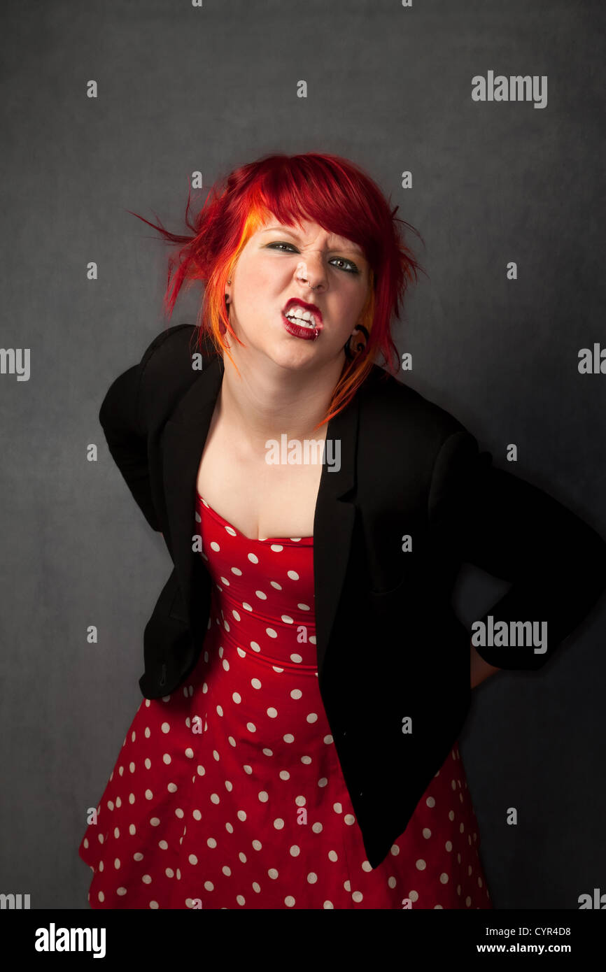 Pretty punky girl with brightly dyed red hair Stock Photo