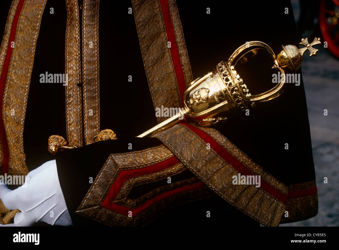 A Beadle macebearer from the City of London holds a ceremonial mace in