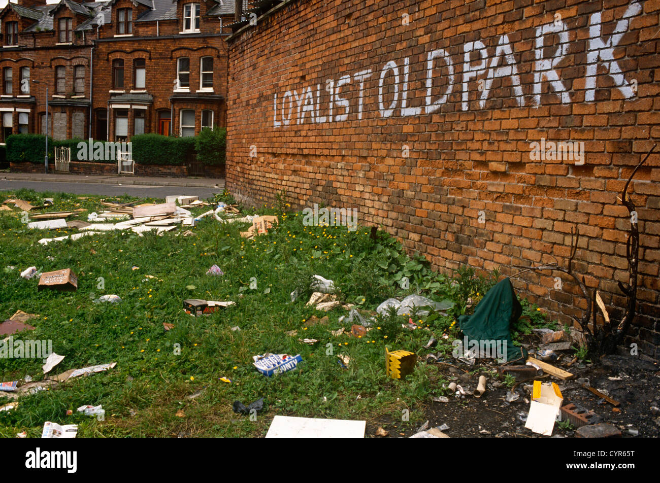 A Loyalist wall and rubbishstrewn wasteground shows the dereliction of