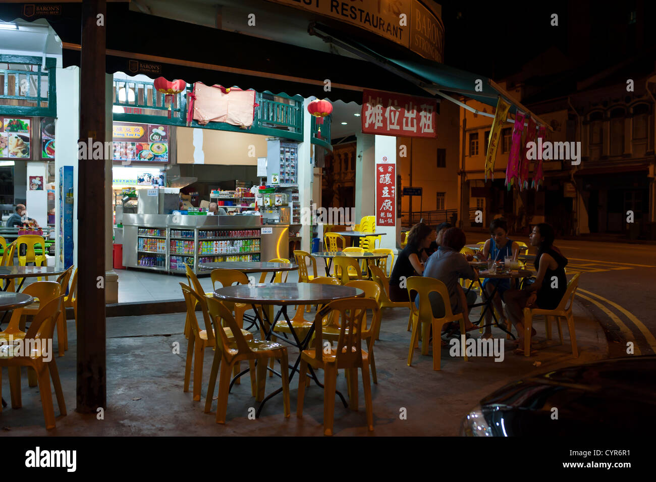 Singaporeans eating on a street at night,Singapore Stock Photo