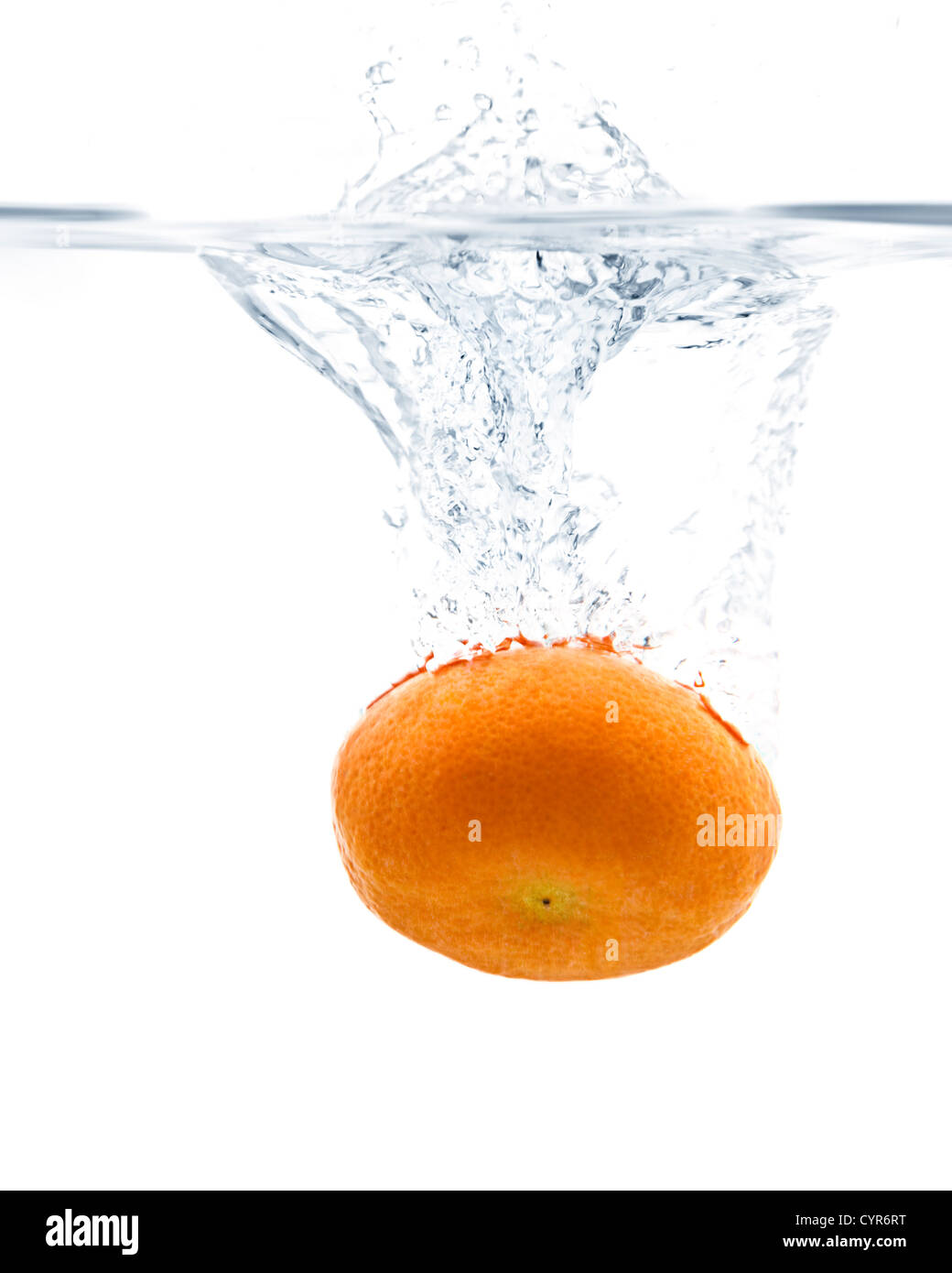 Fresh Tangerine splashing into water with white background Stock Photo