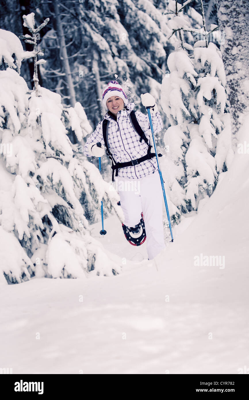 young woman hiking in a snowy forest Stock Photo - Alamy