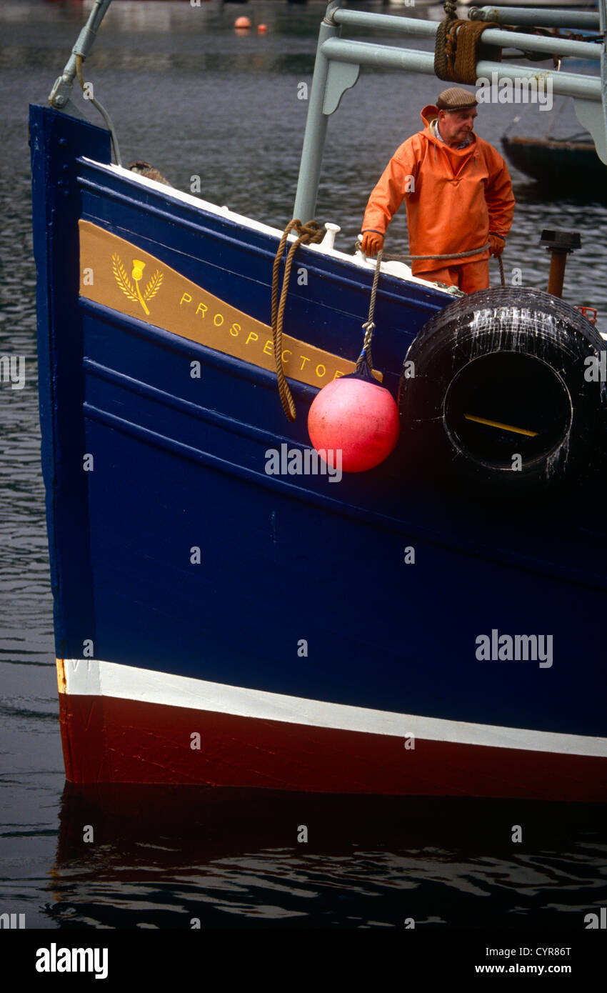 A fisherman returns to his home port of Tarbert on the western Scottish Mull of Kintyre, a quiet community in the western Isles. Stock Photo