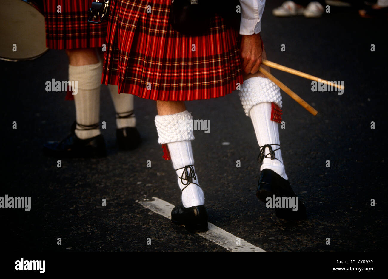 A drummer with the Argyll and Sutherland Highlanders a regiment of the British Army, adjusts a sock during inspection. Stock Photo