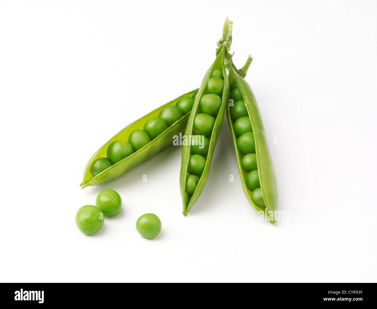 Three pea pods with peas in shot on a white background.Studio isolated ...