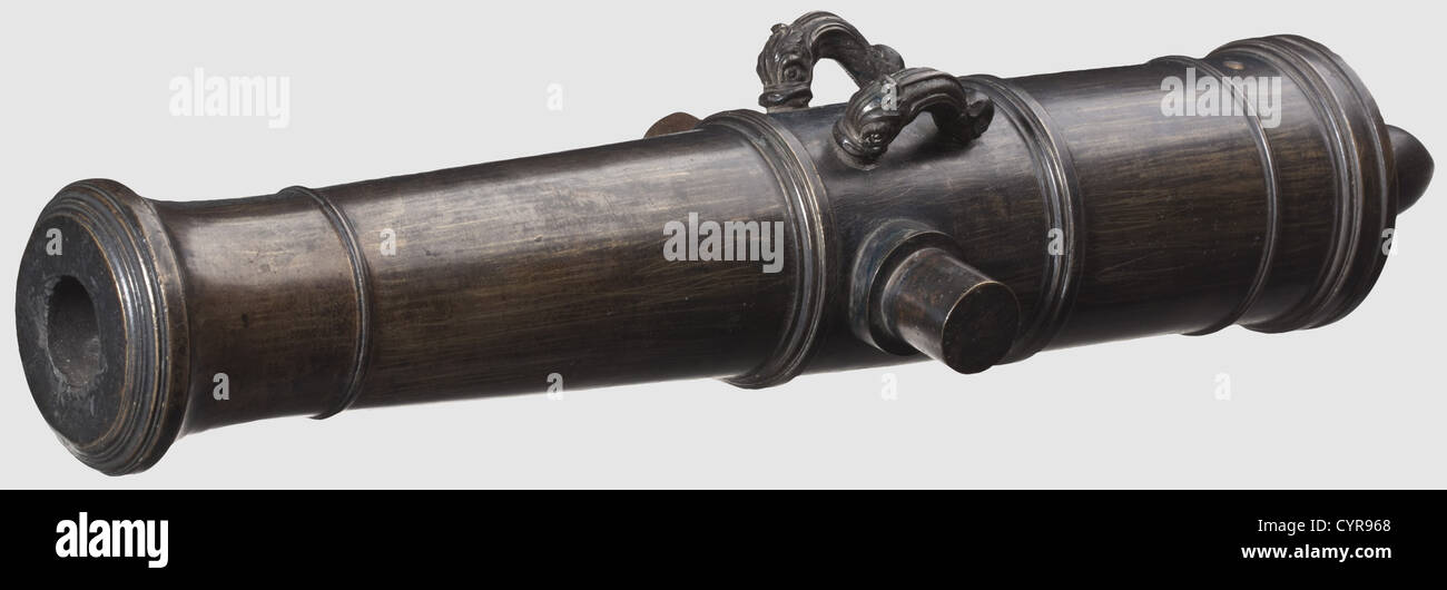 A naval miniature cannon, Europe, 1st half of the 18th century. Bronze with dark age patina. Multi-stage barrrel with a cannon muzzle. Smooth bore in 26 mm calibre. Lateral trunnions and dolphin handles. The breech with a pine-shaped cascabel. Length 45 cm, historic, historical, 18th century, cannon, cannons, artillery, firearm, fire arm, firearms, fire arms, weapons, arms, weapon, arm, fighting device, military, militaria, object, objects, stills, clipping, clippings, cut out, cut-out, cut-outs, Additional-Rights-Clearences-Not Available Stock Photo