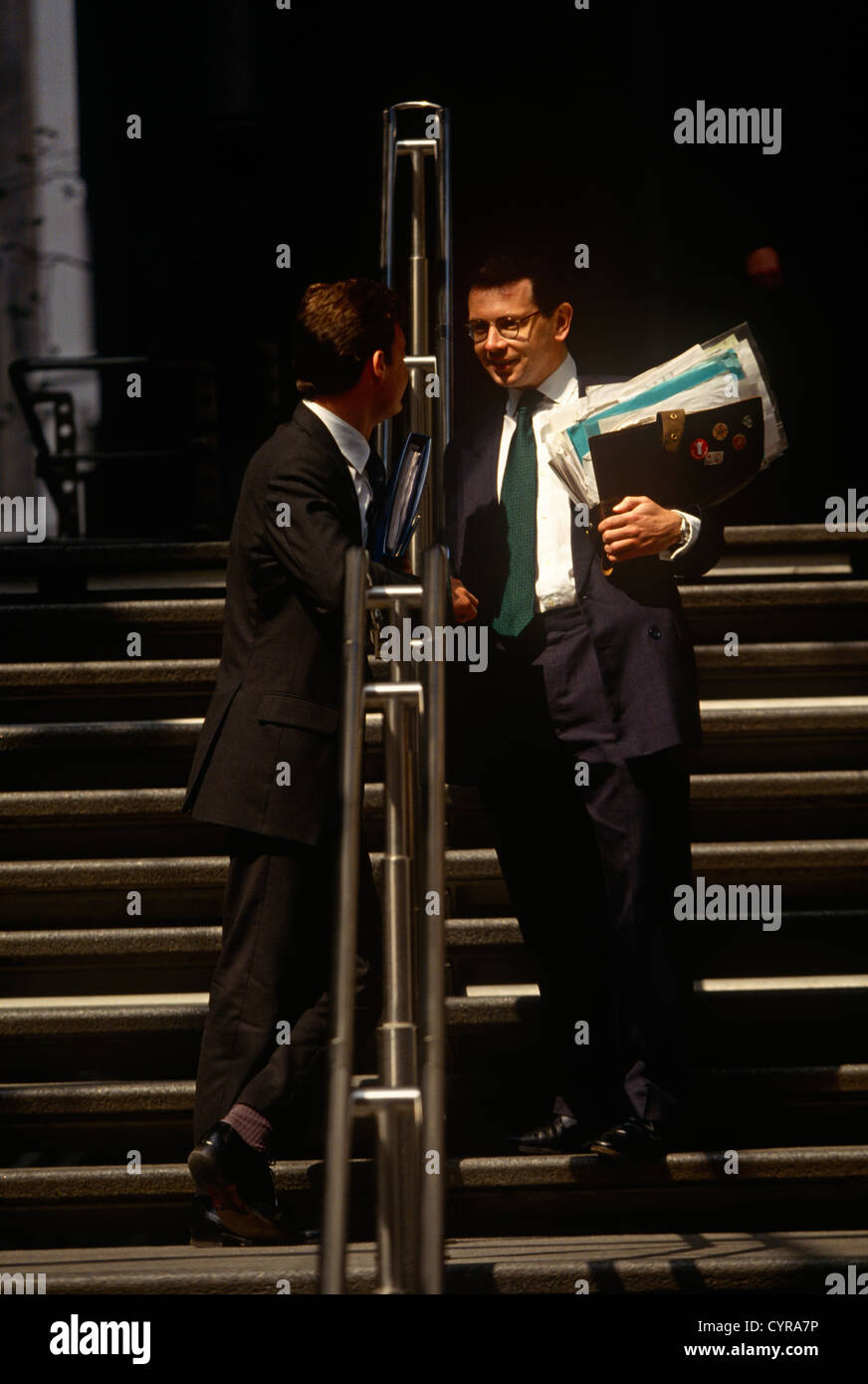 Businessmen in the insurance industry meet and talk outside the Lloyds of London address in the City of London Stock Photo