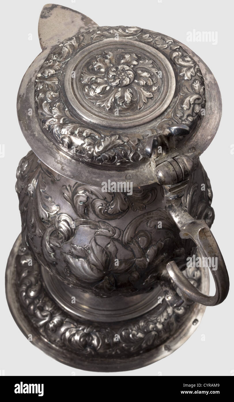 A small silver jug,Augsburg,circa 1690 A pear-shaped jug with a hinged lid and a volute-shaped handle. Body,base,and lid are lavishly decorated with embossed and chiselled vine and flower decoration. Each part is marked with the Augsburg Pyr and the master's mark 'AG',presumably for Master Adolf Gaap,active between 1664 and 1695. Assayer's mark on the bottom of the base. Height 19 cm. Weight 463 g,historic,historical,,17th century,handicrafts,handcraft,craft,object,objects,stills,clipping,clippings,cut out,cut-out,cut-outs,vessel,vessels,Additional-Rights-Clearences-Not Available Stock Photo