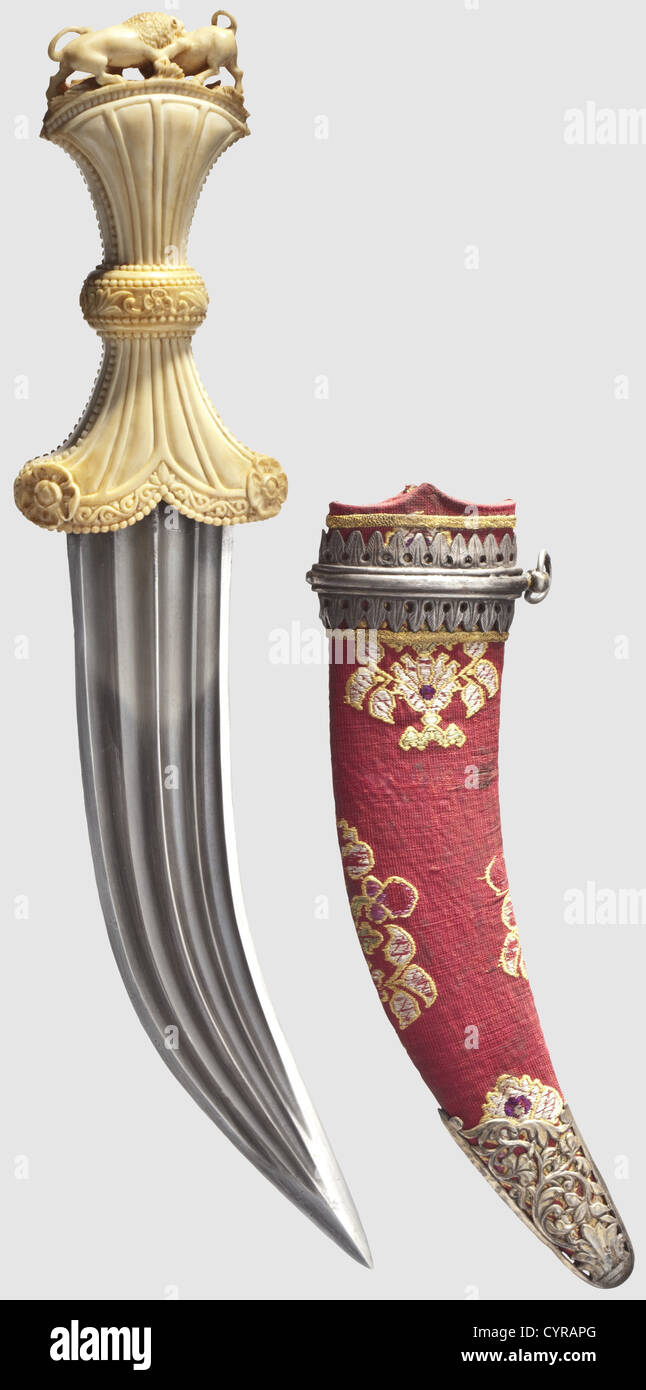 A fine Indian khanjar with a carved ivory grip,19th century Heavy blade with a ridged point and quadruple fullers on each side. Ivory grip,constricted in its middle,finely carved with floral designs,as well as a lion attacking a bull in full relief on the pommel. Later,cloth-covered scabbard with silver mountings from a Tulwar. Length 31 cm. Unusual dagger with the finest carving,historic,historical,19th century,thrusting,thrustings,hand weapon,hand weapons,melee weapon,melee weapons,handheld,blade,blades,weapon,arms,weapons,arms,object,o,Additional-Rights-Clearences-Not Available Stock Photo