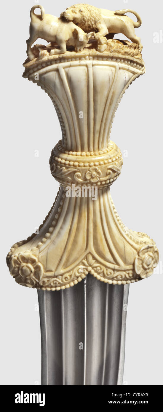 A fine Indian khanjar with a carved ivory grip,19th century Heavy blade with a ridged point and quadruple fullers on each side. Ivory grip,constricted in its middle,finely carved with floral designs,as well as a lion attacking a bull in full relief on the pommel. Later,cloth-covered scabbard with silver mountings from a Tulwar. Length 31 cm. Unusual dagger with the finest carving,historic,historical,19th century,thrusting,thrustings,hand weapon,hand weapons,melee weapon,melee weapons,handheld,blade,blades,weapon,arms,weapons,arms,object,o,Additional-Rights-Clearences-Not Available Stock Photo
