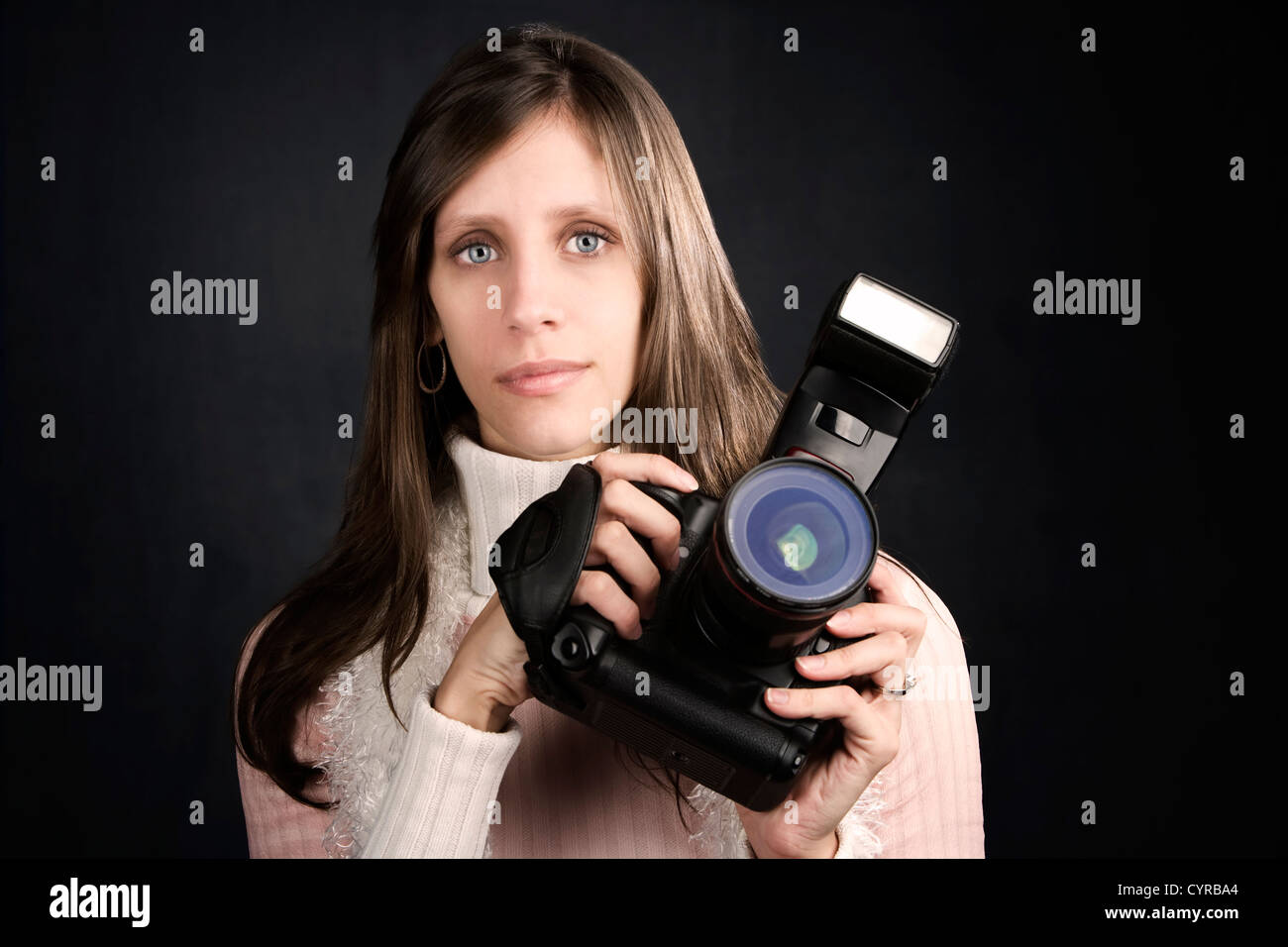Pretty photographer with a professional camera and flash Stock Photo ...