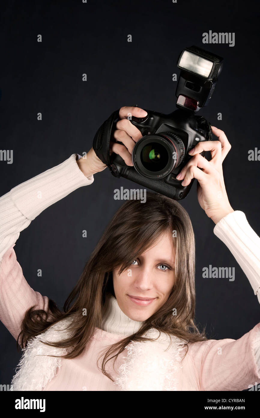 Pretty photographer with a professional camera and flash Stock Photo ...
