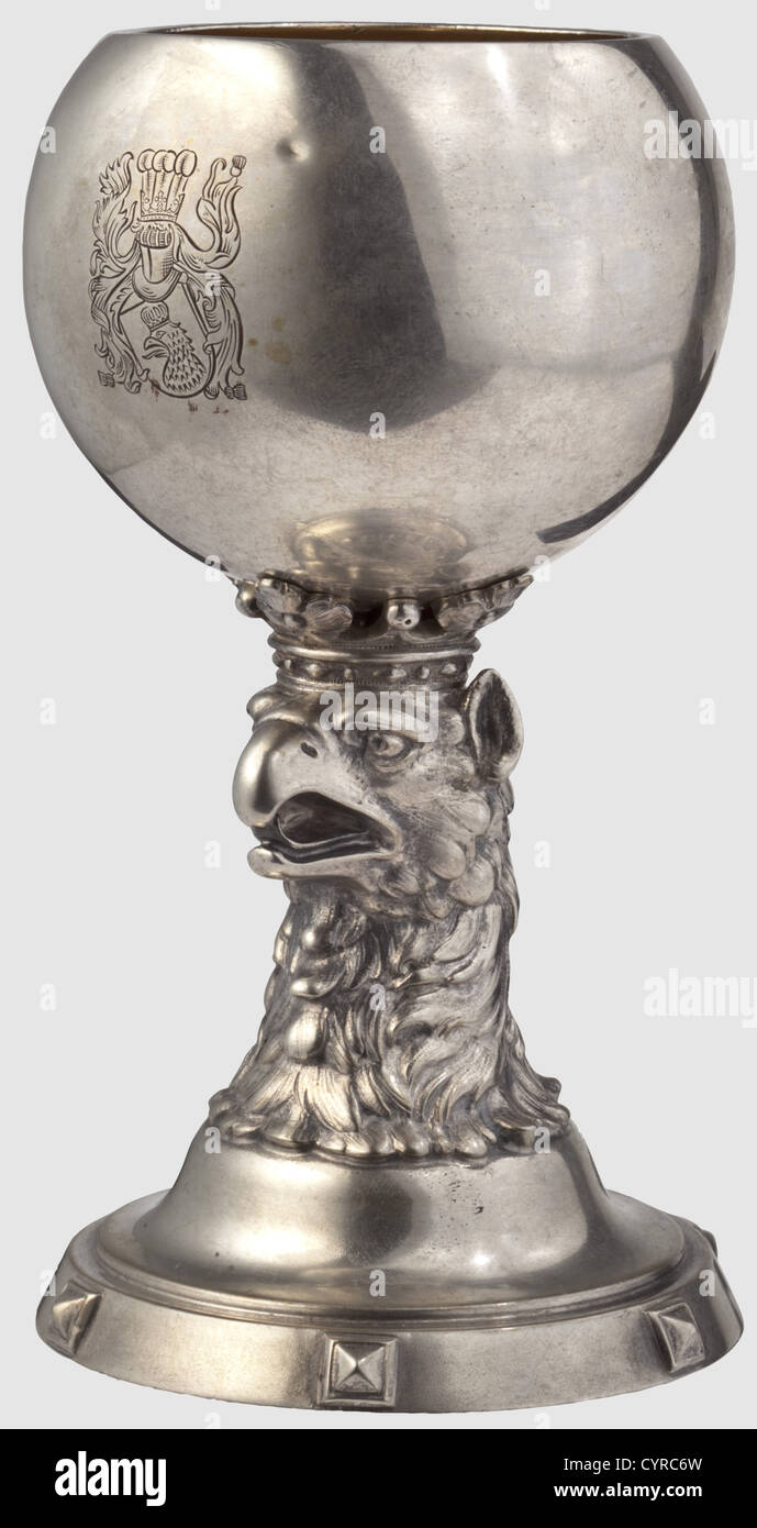 General Field Marshal August von Mackensen(1849 - 1945),a silver goblet for achieving the hereditary nobility in 1899 Silver,gilt interior.On the front of the globular bowl the engraved coat of arms of von Mackensen,an eagle's head with royal crown and date '27.Januar 1899' on the reverse side.The shaft has the form of a crowned gryphon's head,the circular base with continuous decorative studs with diamond cut as well as jeweller's mark and hallmark 'Wilm - 800'.Height 13.5 cm,weight 213 g.Awarding a coat of arms with an eagle,the heraldic animal of,Additional-Rights-Clearences-Not Available Stock Photo
