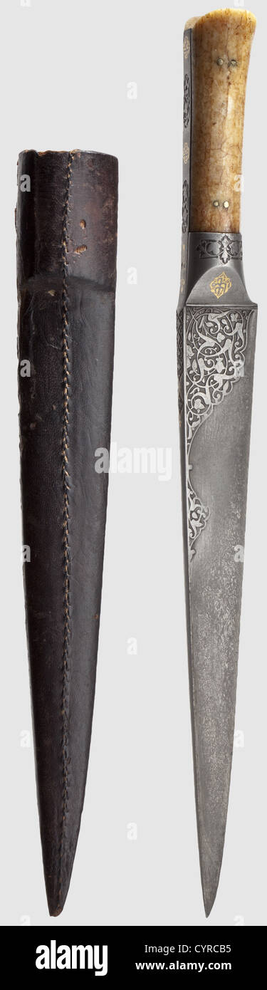 A Persian chiselled kard,circa 1800 Strong wootz-Damascus blade cut along the back. Both sides at the forte chiselled with leafy vine ornaments. The wootz-Damascus grip ferrule and frame with gold-inlaid inscription cartouches and chiselled cartouches with floral designs. Riveted grip scales of fossilised walrus ivory. Leather-covered(damaged)wooden scabbard. Length 36.5 cm,historic,historical,19th century,Persian Empire,object,objects,stills,clipping,clippings,cut out,cut-out,cut-outs,thrusting,thrustings,hand weapon,hand weapons,melee weap,Additional-Rights-Clearences-Not Available Stock Photo