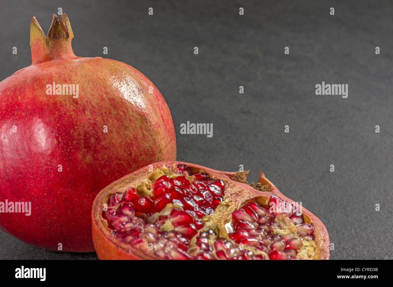 Pomegranate on a slate plate Stock Photo