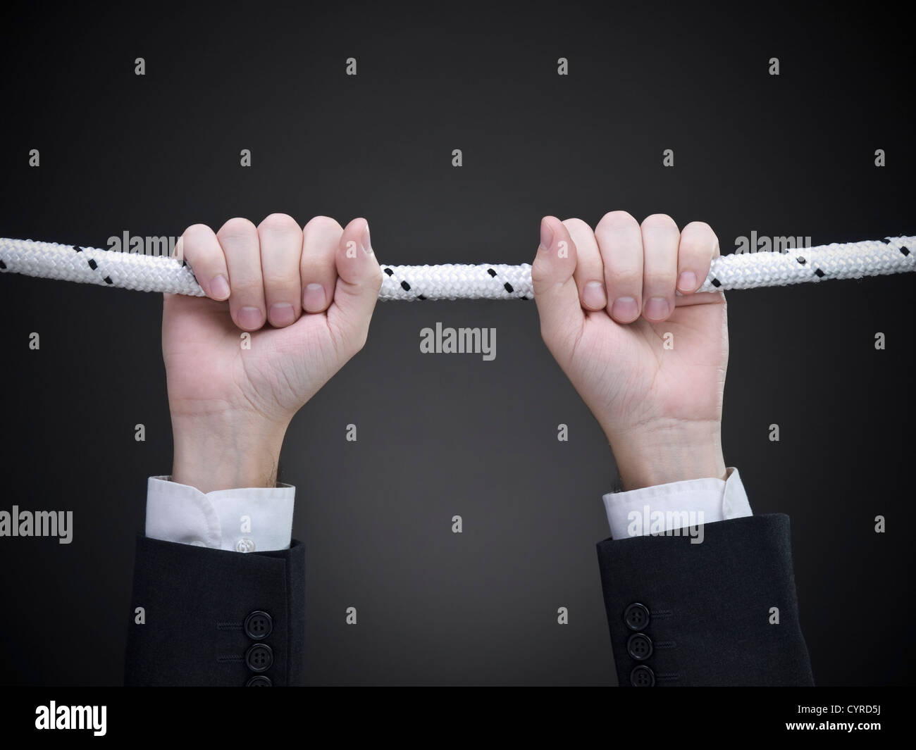Close up on a businessman's hands hanging on a rope Stock Photo Alamy