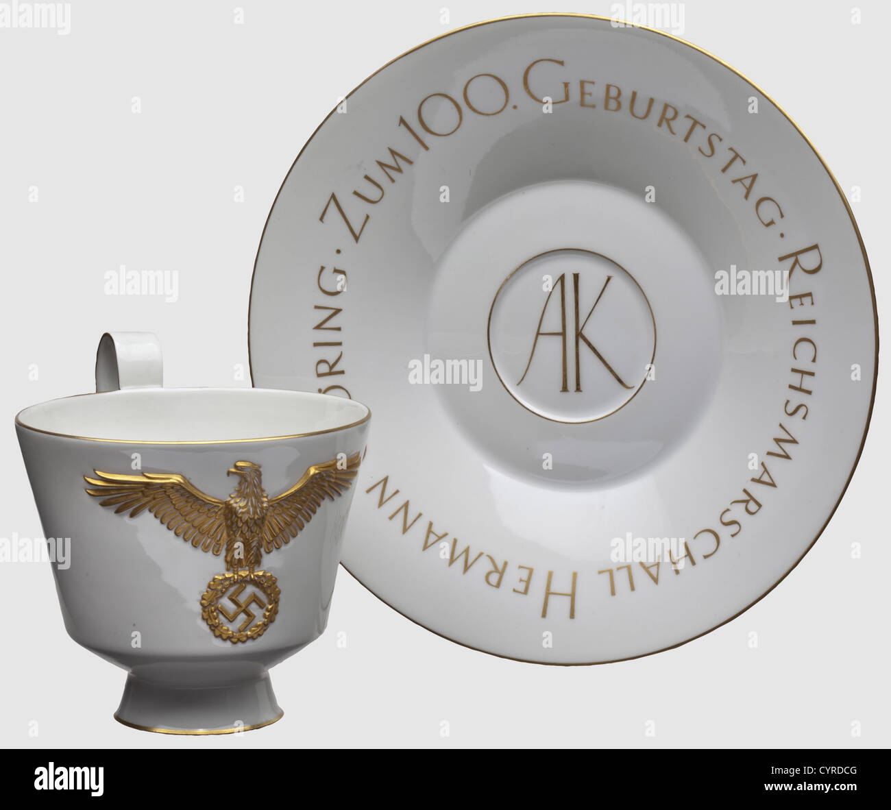 Hermann Göring - a KPM presentation cup,on the 100th birthday of Antonia Kropska White,glazed porcelain with gold decorated rims,a gilt national eagle in relief on the obverse side,and a golden rose in the cup.A sceptre mark in underglaze blue and a red KPM imperial orb mark on the bottomn as well as numbers '126/695' Height 10.6 cm.The saucer,designed and marked en suite,bears the golden circumscription 'Reichsmarschall Hermann Göring - Zum 100.Geburtstag' and the initials 'AK' in the centre.Diameter 19.6 cm.Transmittal letter and letter of congratu,Additional-Rights-Clearences-Not Available Stock Photo