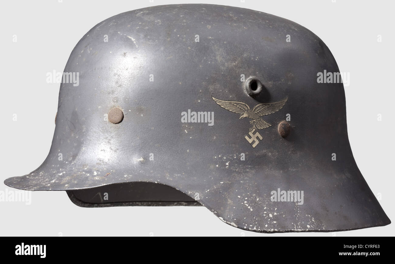 A parade steel helmet for officers,with both insignia Aluminium shell,similar to M 16,with Luftwaffe blue paint. The eagle is 95 % and the national shield 90 % intact. One of the five attachment clamps on the inner liner is missing,inner liner and chinstrap damaged,traces of corrosion,historic,historical,1930s,1930s,20th century,Air Force,branch of service,branches of service,armed service,armed services,military,militaria,air forces,object,objects,stills,clipping,clippings,cut out,cut-out,cut-outs,defensive arms,weapon,weapons,pro,Additional-Rights-Clearences-Not Available Stock Photo