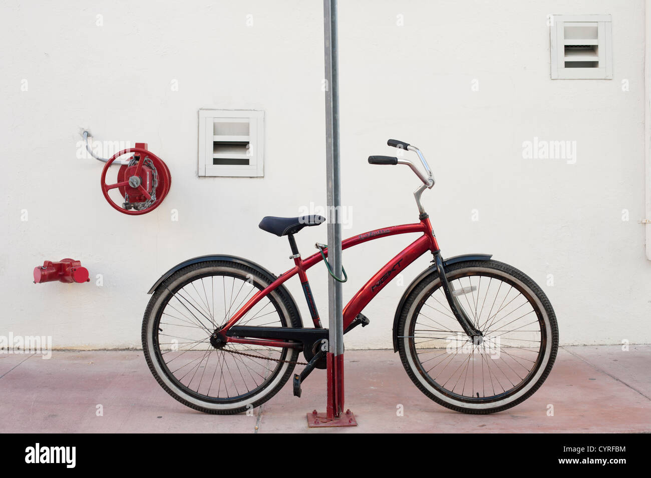 A Miami Beach Cruiser Bicycle locked to a street sign post on Atlantic Drive South Beach Miami. Cow horn Handlebars Stock Photo