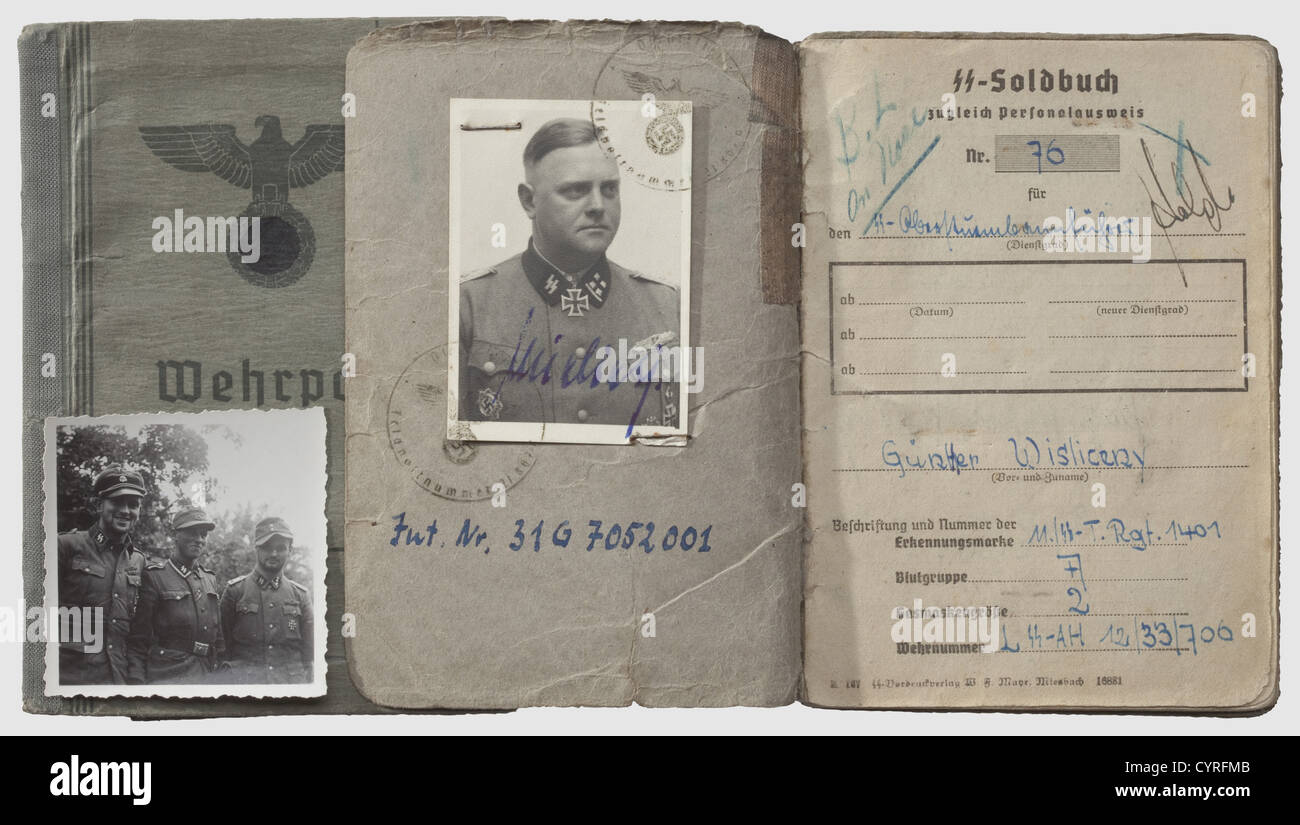 Swords Winner SS-Obersturmbannführer Günther Wisliceny,Soldbuch,Wehrpass,and Death's Head Ring The Soldbuch(identity/pay document)dated 21 September 1944 with ID photo in uniform and 15 entries for awards,including the Knight's Cross with Oak Leaves and Swords,the Knight's Cross with Oak Leaves,the Knight's Cross,the German Cross in Gold,the Close Combat Clasp in Bronze,Silver and Gold,the Wound Badge in Black,Silver and Gold,and the SS Long Service Award 3rd Grade. Typewritten replacement Wehrpass(military registration book)dated 8 May 1945 wit,Additional-Rights-Clearences-Not Available Stock Photo