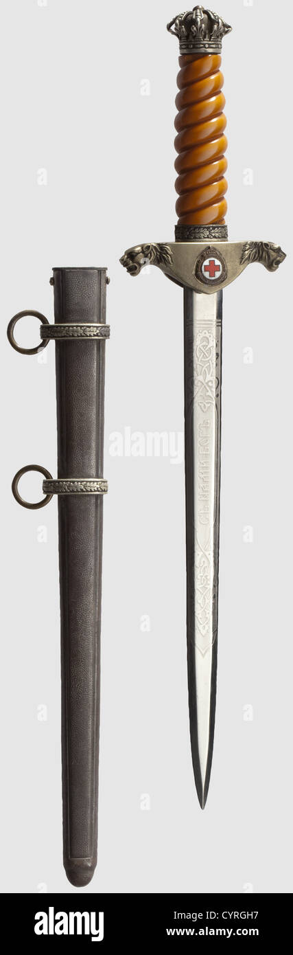 An honour dagger for officers of the royal Bulgarian army,Reign of Tsar Boris III(1918-1943)Nickel-plated blade with the Cyrillic cipher 'B III' on one side and the Cyrillic motto 'God with us' on the other face each between decorative floral etchings. Silver-plated quillons with lion head finials,the coat of arms riveted on the obverse side,and an enamelled miniature of the Red Cross Honours Medal(re-attached with glue)on the reverse side. Silver-plated,openwork pommel in the shape of the Tsar's crown,slightly deformed,the cross missing. Orange-colou,Additional-Rights-Clearences-Not Available Stock Photo
