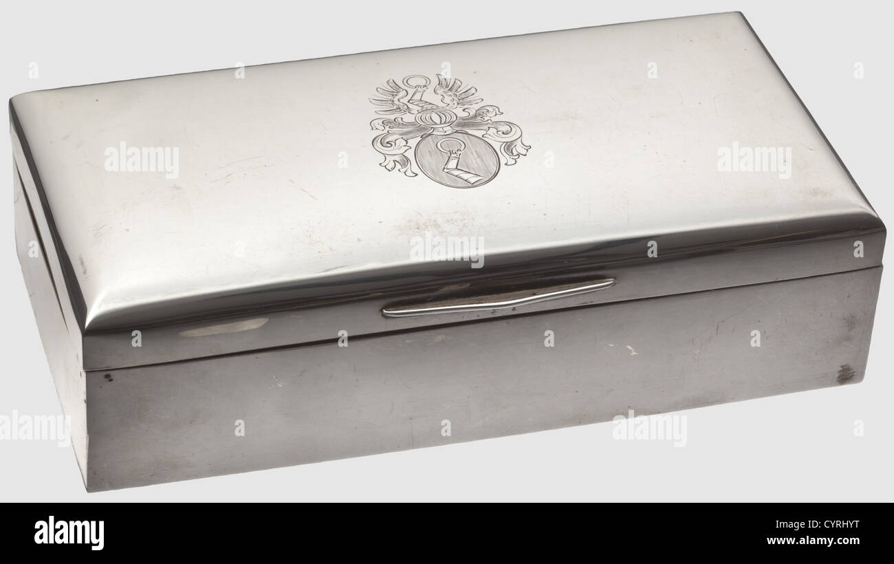 Hermann Göring,a silver cigar box Silver,smooth surfaces,engraved Göring's coat of arms on the slightly cambered lid. On the bottom the hallmark '800 - WTB' as well as the number '18129'. Interior lining of tropical wood. Dimensions 20 x 10.2 x 5.5 cm,total weight 565 g,historic,historical,1930s,1930s,20th century,NS,National Socialism,Nazism,Third Reich,German Reich,Germany,German,National Socialist,Nazi,Nazi period,fascism,object,objects,stills,clipping,clippings,cut out,cut-out,cut-outs,storage,box,boxes,cabinet,chest,cabine,Additional-Rights-Clearences-Not Available Stock Photo