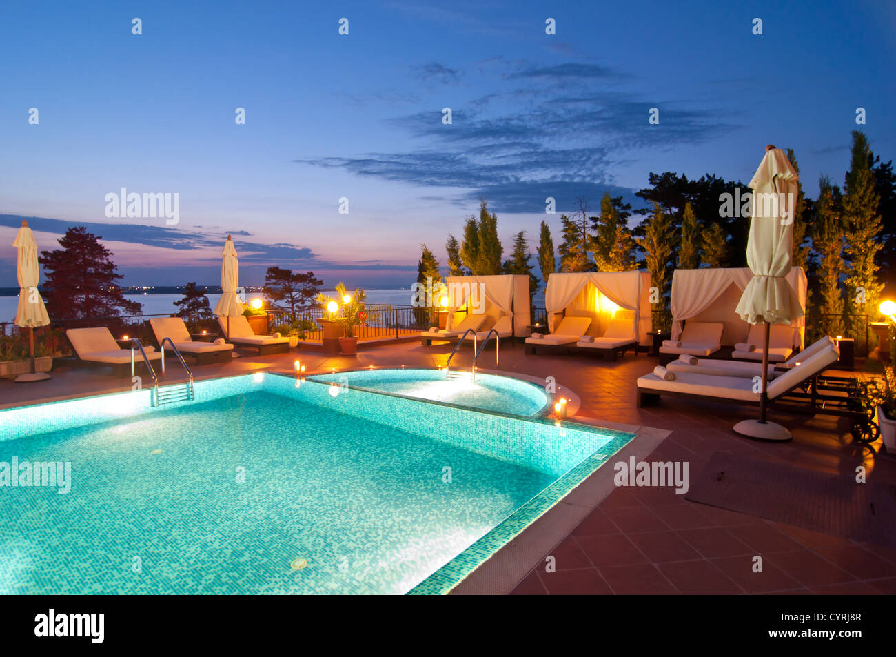Swimming pool of luxury hotel at night Stock Photo - Alamy