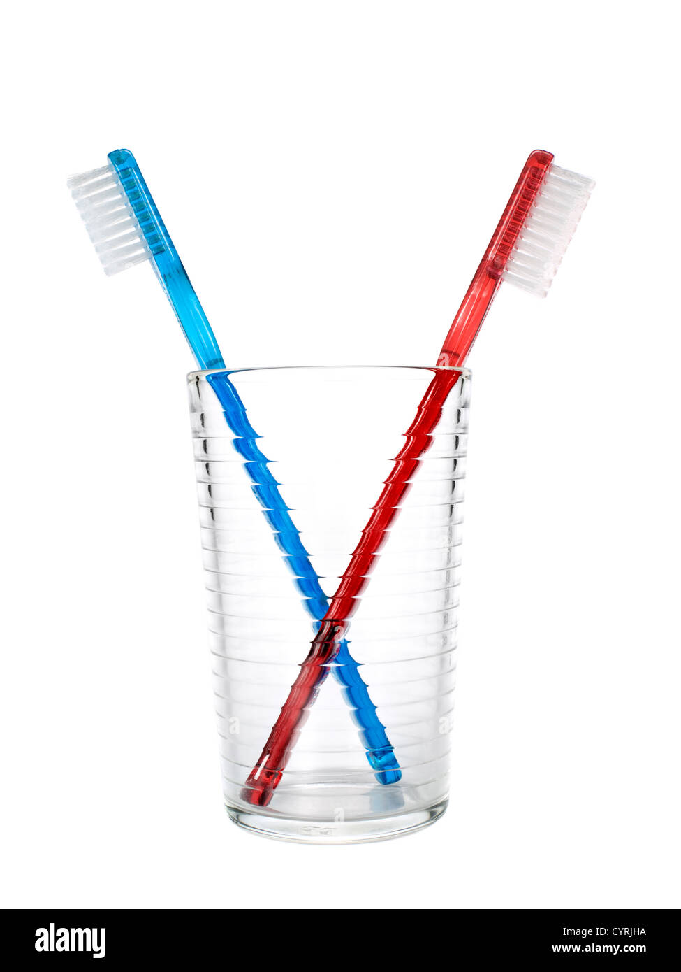 Two toothbrushes in a glass over white background Stock Photo - Alamy