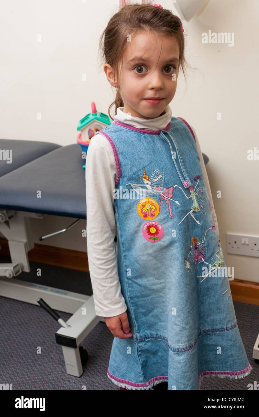 Six year old girl with bravery stickers after a visit to the Doctor. Stock Photo