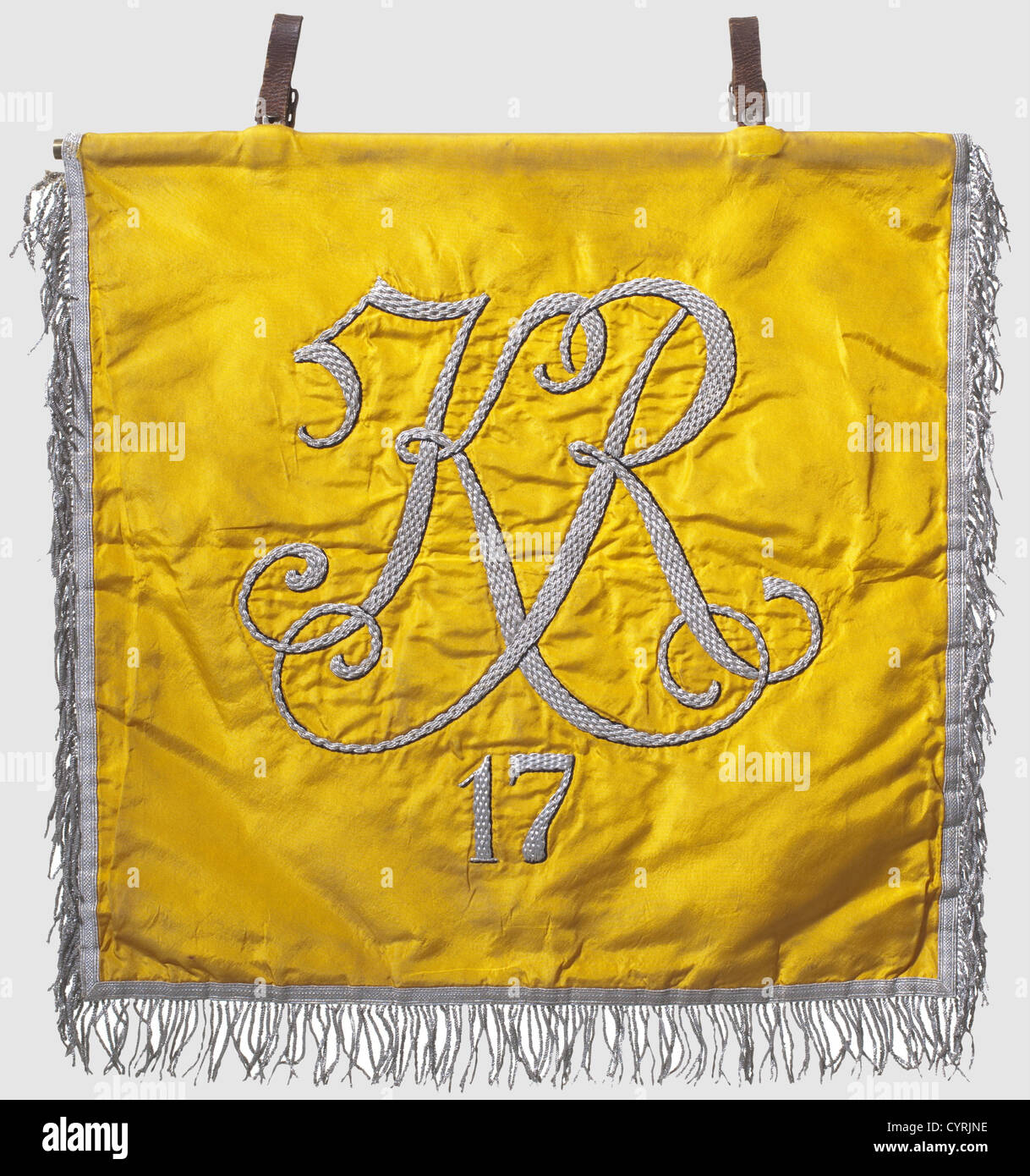 A trumpet banner,for the 17th cavalry regiment Golden yellow silk with a silver eagle embroidered on the front,the contours and feathers set off in black,the talons and the beak embroidered in gold.The reverse side displays the cipher 'KR 17' embroidered in silver.Silver fringe on three sides and two attachment loops.Vivid colour,slightly soiled.42 x 44 cm.The 17th(Bavarian)Mounted Regiment,the so-called 'Bamberger Reiter',was raised in 1920 in the VII Defense District and belonged to the 7th Reichswehr Division.The squadrons were stationed in Bam,Additional-Rights-Clearences-Not Available Stock Photo