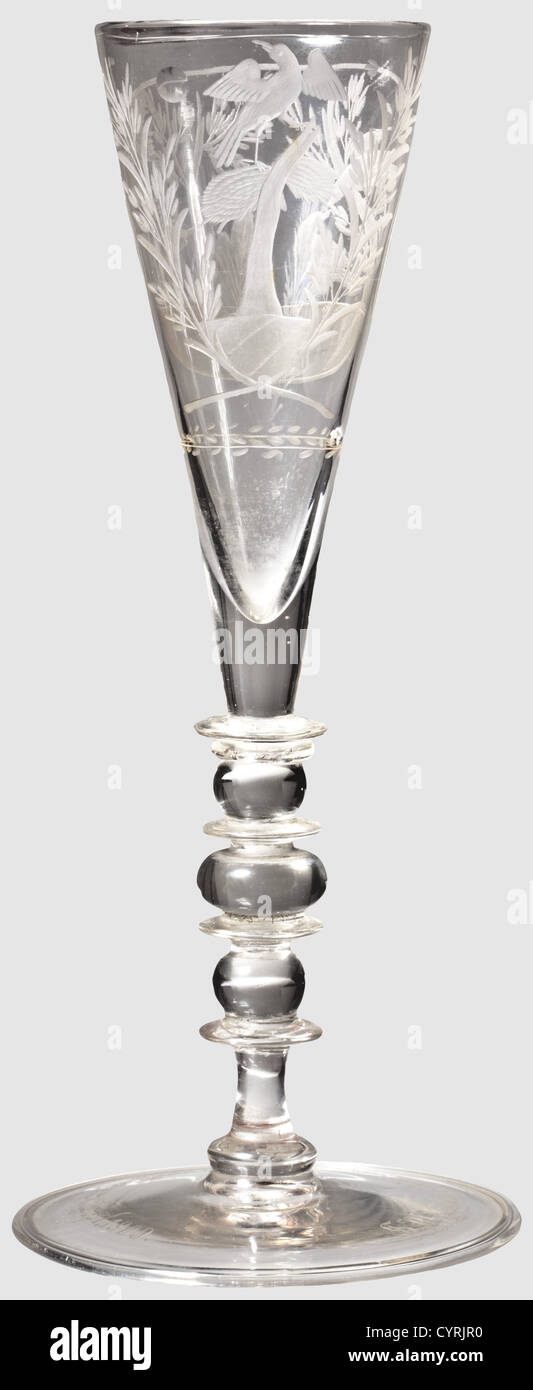 King Friedrich August III of Saxony - a baroque cut glass,Silesian,circa 1750,with a later dedication from 1909 Slender Champagne flute of discoloured glass.The cup decoratively cut with birds and hunter among trees.Baluster stem with elaborately arranged decorative disks.The bottom of the foot shows the typical molten glass tear-off pattern.A dedication inscription surrounding the foot,'S.M.König Friedrich August von Sachsen,11.Sept.1909'( H.M.King Friedrich August of Saxony,11 Sept.1909).Height 25.2 cm.Friedrich August III(1865 - 1932)King ,Additional-Rights-Clearences-Not Available Stock Photo