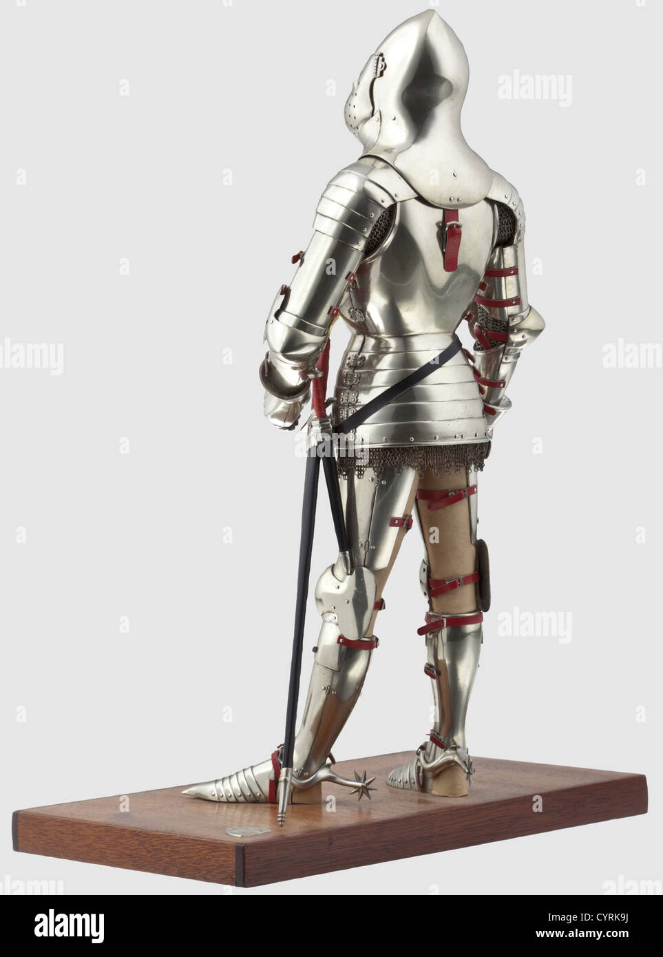 Peter Wroe - A fine Spanish miniature full armour,in the style of 1425-1450,20th century Accurately represented to scale in white metal alloy,leathered and highly detailed throughout,partly articulated,including 'great' bascinet attached to the cuirass by straps front and rear,the cuirass and fauld each hinged on the left and closed by straps on the right,mail skirt,'hourglass' gauntlets,shaped rectangular besagews,sabatons attached by laces,rowel spurs,rondel dagger and arming sword. On its leather-covered figural stand with carved painted resin fa,Additional-Rights-Clearences-Not Available Stock Photo