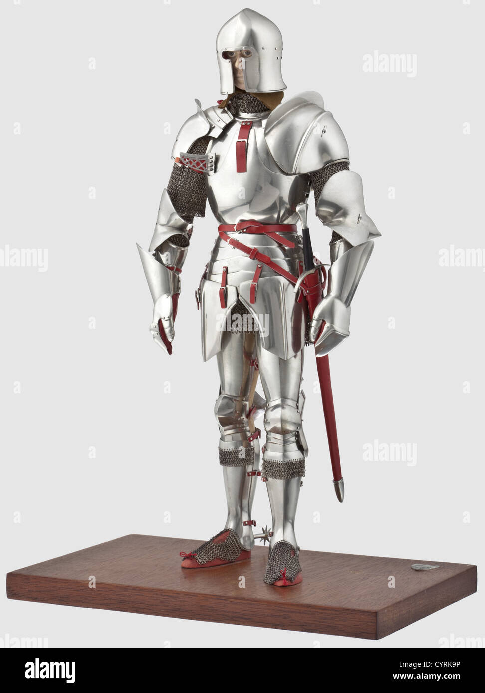 Peter Wroe - A fine Milanese miniature full armour,in the style of 1470 - 1480,20th century Accurately represented to the scale in white metal alloy,leathered and highly decorated throughout,partly articulated,including barbuta,mail shirt,cuirass of two-part construction front and rear(the cuirass and fauld hinged on the left and closed by straps on the right),spaulders attached by lace,the left-hand haute piece and counter each fitted with a reinforcing-piece,gauntlets with long pointed cuffs,poleyns fitted with mail lower borders,mail sabatons,r,Additional-Rights-Clearences-Not Available Stock Photo