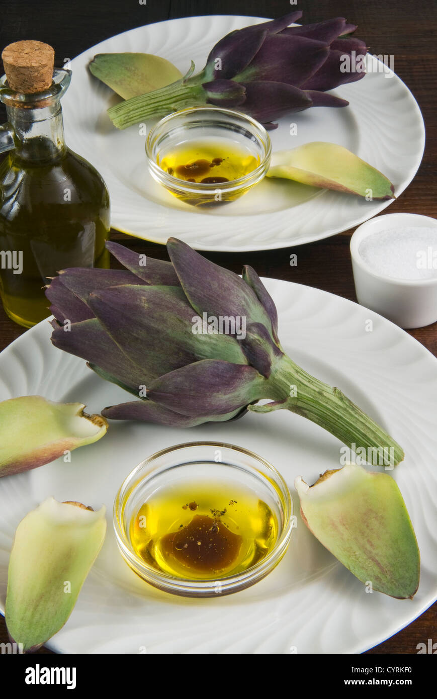 Artichoke with dipping sauce (oil, salt, pepper and vinegar) Stock Photo
