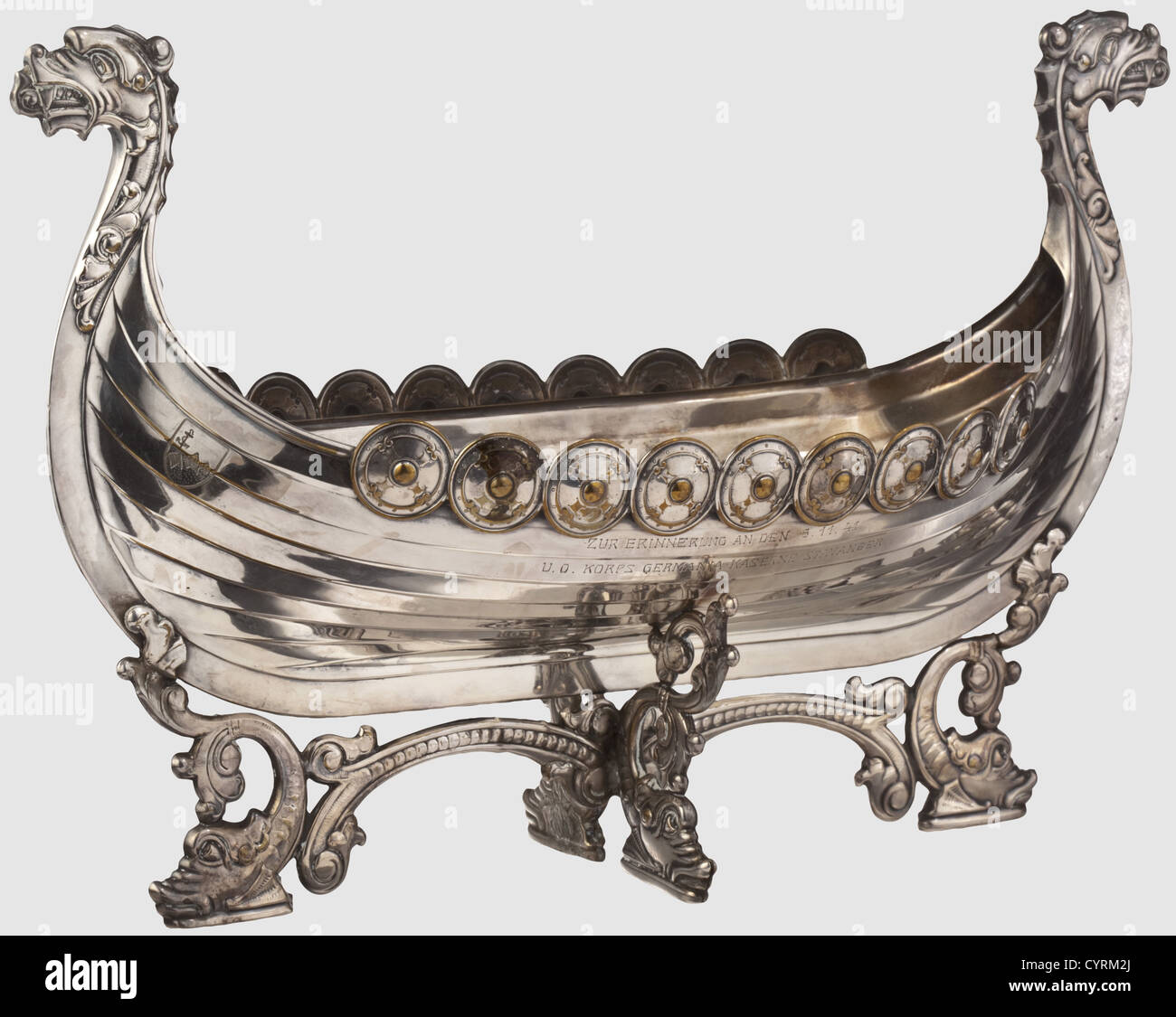 A commemoration gift from naval defense Stavanger,dated 5 November 1941 Silver-plated Viking ship with characteristical dragon's heads and side-mounted shields,one side with engraved inscription 'Zur Erinnerung an den 5.11.41 - U.O.Korps Germania-Kaserne Stavanger'(In memory of 5th November 1941 - NCOs of Gemania-barracks Stavanger).Cruciform base with dolphins,maker's mark and serial number '846'.Length 35.5 cm,height 22.8 cm.The commanding officer of naval defense Stavanger was not only in command of a flotilla but also of art,Additional-Rights-Clearences-Not Available Stock Photo