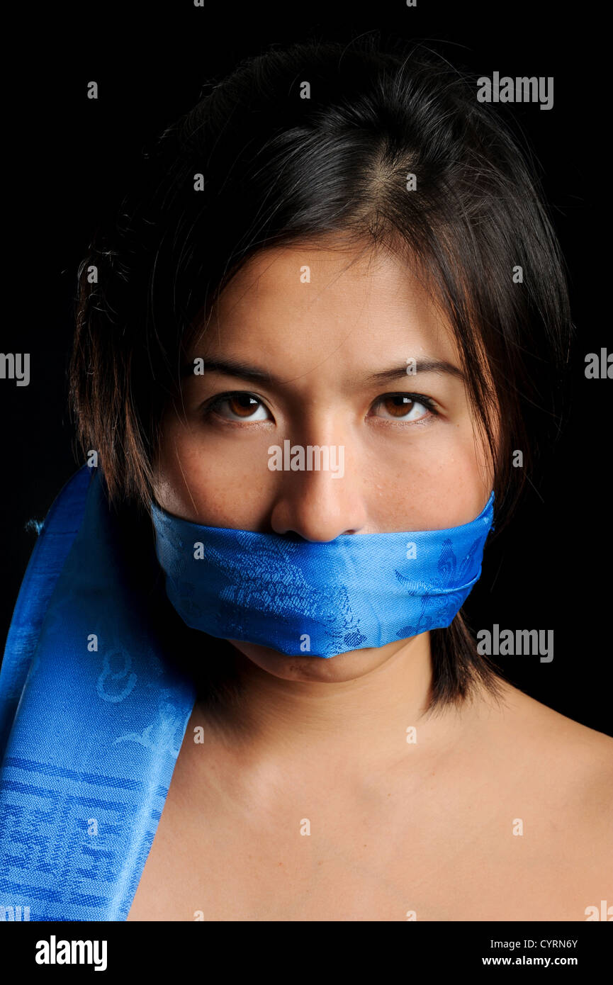 Girl gagged with blue scarf is not happy about it Stock Photo - Alamy
