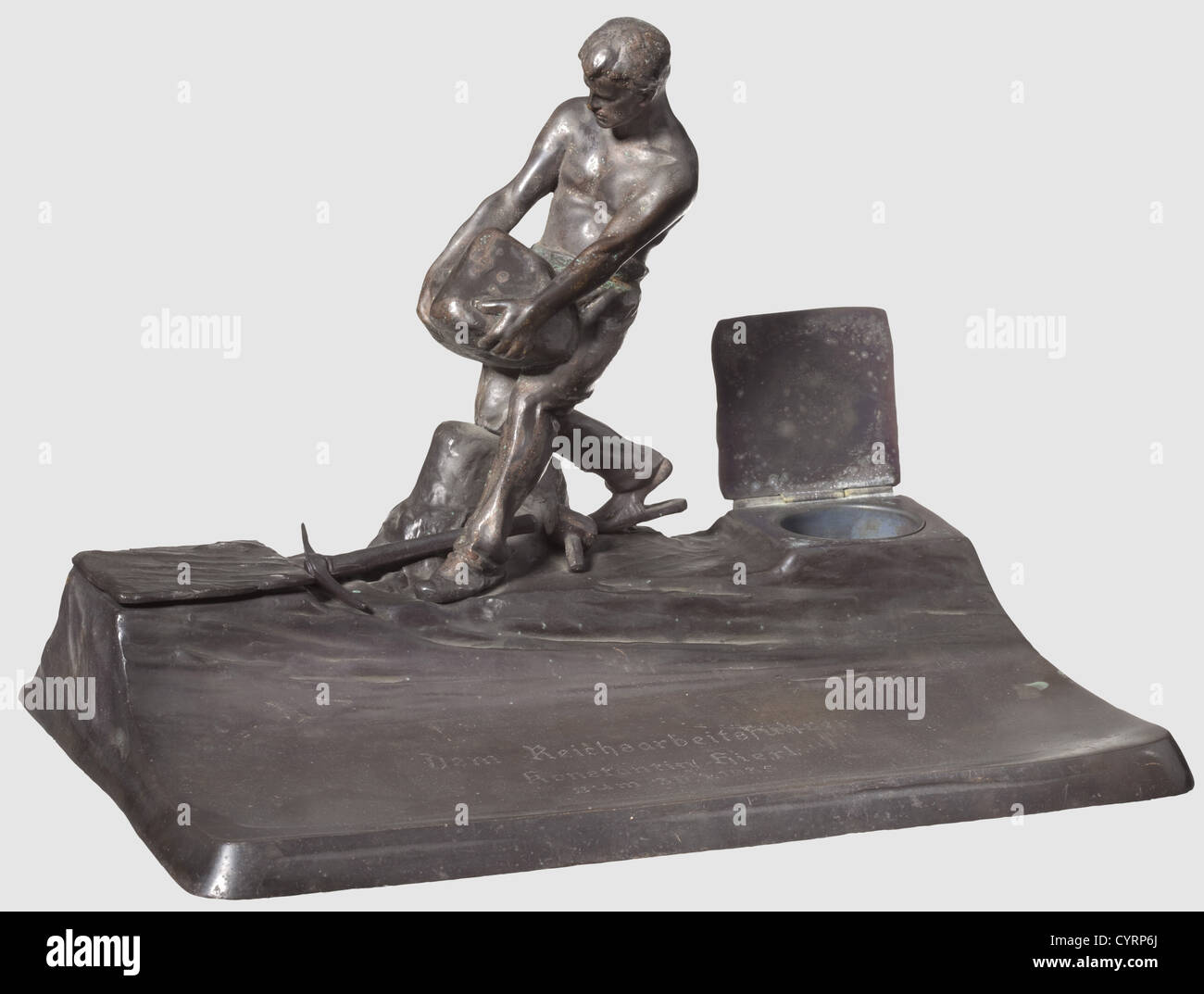 Konstantin Hierl,a presentation writing table set made of blackened bronze Modelled figure of a quarryman with pickaxe and sledgehammer between lidded containers for ink and blotting sand. Lateral artistïs signature 'L. Eisenberger'. The depositing surface engraved 'Dem Reichsarbeitsführer Konstantin Hierl zum 30.1.1935'(To Reich Labour Leader Konstantin Hierl on 30 January 1935). 33 x 22 x 23 cm,historic,historical,people,1930s,20th century,NS,National Socialism,Nazism,Third Reich,German Reich,Germany,German,National Socialist,Nazi,Nazi period,Additional-Rights-Clearences-Not Available Stock Photo