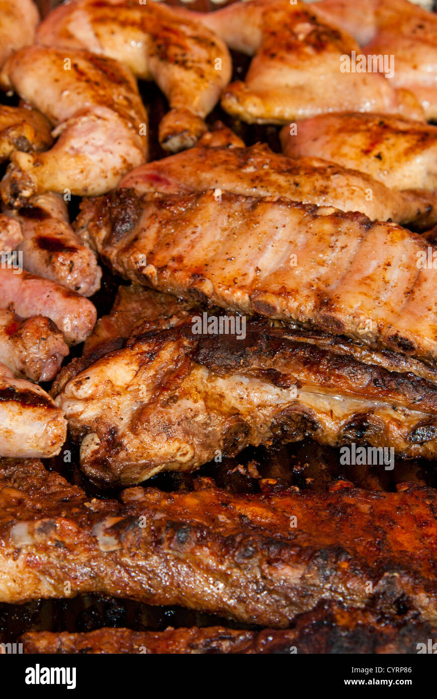 Roasted chicken legs, pork ribs and sausages Stock Photo