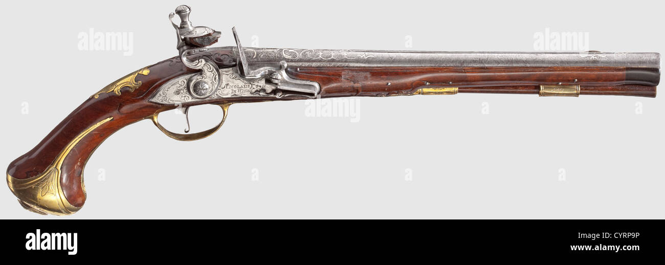 A long flintlock pistol,Nicolaus Koch,Vienna circa 1730.Round and smooth Ottoman Damascus barrel in 15 mm calibre with silver front sight on the midrib.At the breech palmette-shaped silver inlays with brass-lined Ottoman master's mark.Cut and engraved flintlock(the screw and the top cockjaw are good replacements)with signature 'NICOLAUS KOCH IN WIENN'.Carved walnut stock with horn nose and engraved brass furniture,the pommel cap with mascaron in relief.Later ramrod with brass plate.Length 49 cm.Nicolaus Koch,Vienna,mentioned 1715-32,fellow of the,Additional-Rights-Clearences-Not Available Stock Photo