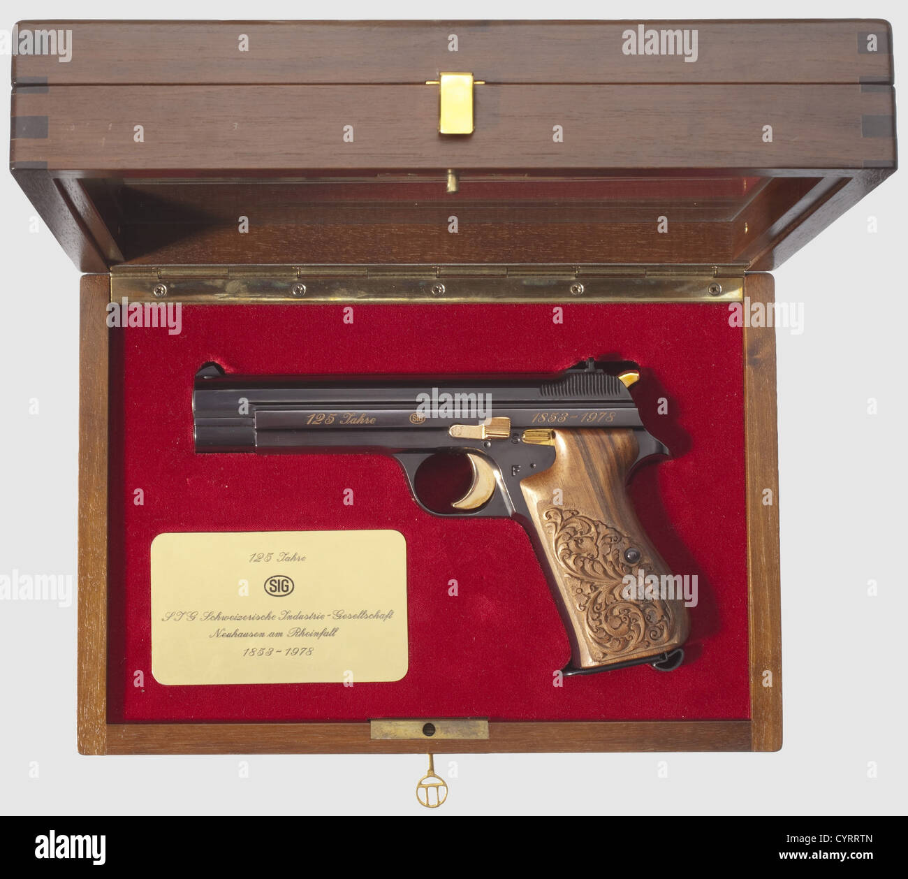 Commemorative pistol JP 210,1978,in its case,cal. 9 mm Parabellum,no. JP 054. Matching numbers. Bright bore. Eight shots. On left side of slide gold-inlaid engraving "125 Jahre - SIG - 1853 - 1978". Complete original highly polished finish,grip frame lightly plum-coloured. Trigger,locking lever,safety and hammer gilded. Carved walnut grip panels. Magazine. Comes in walnut case with window,dimensions 30 x 20 x 9 cm,lined with red velvet,commemorative badge fitted in case bottom. Case key. Rare collectorïs item in brand new condition from a limited edit,Additional-Rights-Clearences-Not Available Stock Photo