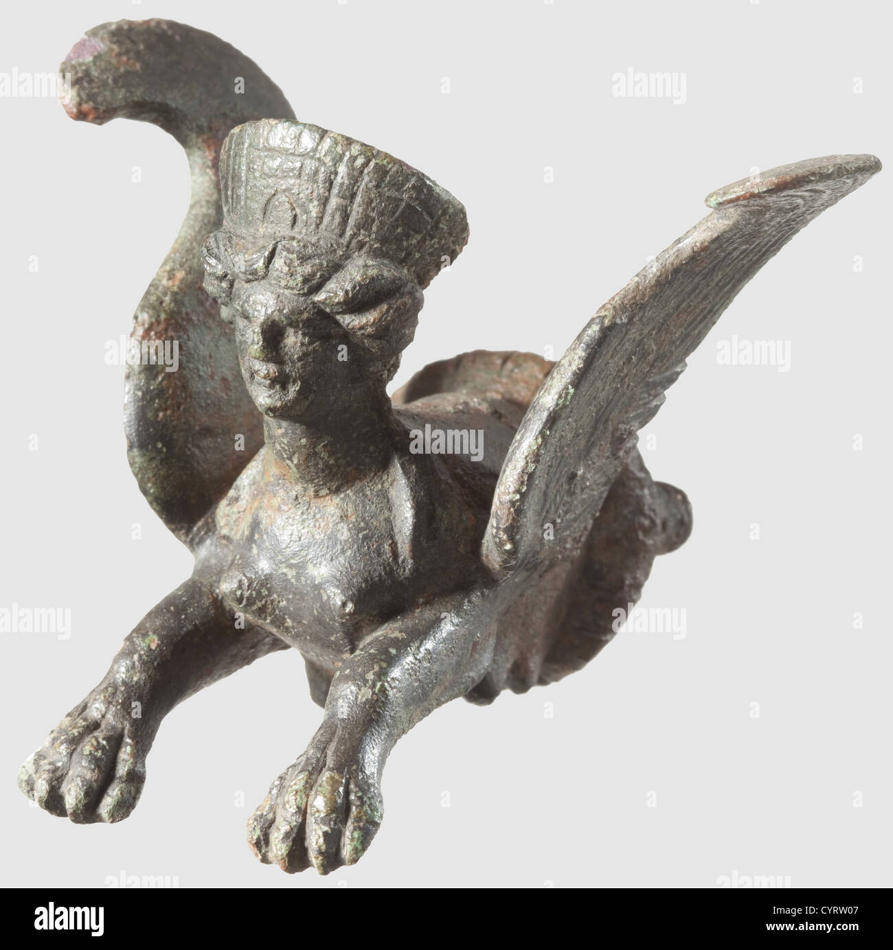 A Roman protome in the shape of a sphinx,1st/2nd century AD. Three-dimensional front part of a sphinx made from bronze,finely detailed engraved woman's head as well as a winged lion's body. On the reverse side two pins for fixation. The inside with crystallised residues of an adhesive. Height 6 cm. Provenance: South German private collection,70s and later,historic,historical,ancient world,ancient world,ancient times,object,objects,stills,clipping,cut out,cut-out,cut-outs,mediterranean,precious metal,precious metals,sculpture,sculptures,stat,Additional-Rights-Clearences-Not Available Stock Photo