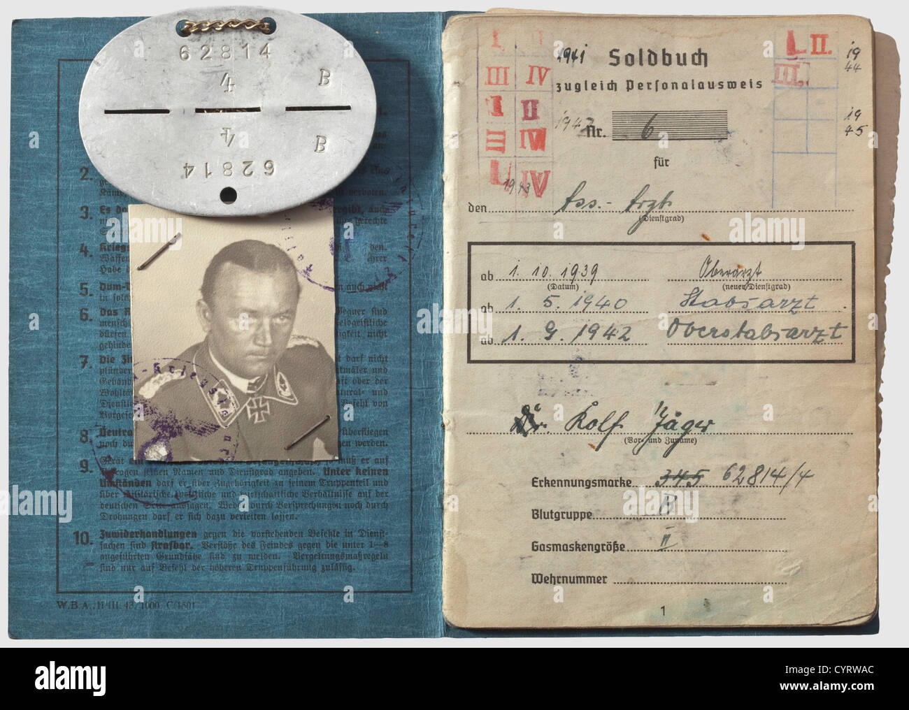 Knight's Cross winner Dr. Rolf Jäger (1912 - 1984), a Soldbuch (pay document) and an identification disc The Soldbuch proceeds in an orderly manner with entries from 26 August 1939 until the final entry on 1 May 1946, while in British captivity. Full of entries, for example in regards to awards: Commemorative Medal of 1 October 1938, Long Service Award 4th Class, Iron Cross 2nd and 1st Class of 1939, Knight's Cross of the Iron Cross, Luftwaffe Ground Combat Badge, War Merit Cross 2nd and 1st Class with Swords. After the war, and while in British captivity, Jäge, Stock Photo