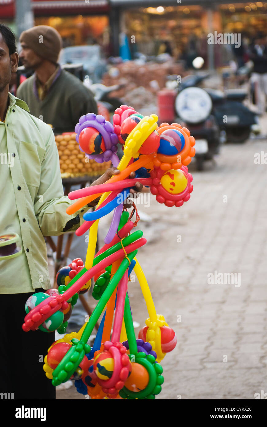 Vendor selling toys in a street market, New Delhi, India Stock Photo