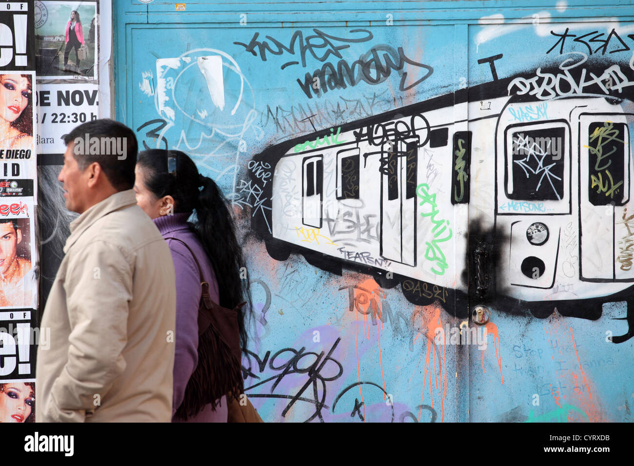 Graffiti street art showing tube subway train, two passersby, Madrid, Spain Stock Photo