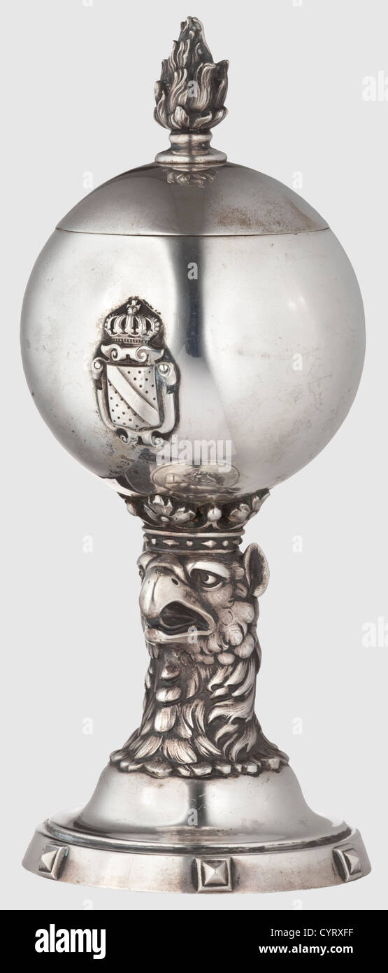 1st Baden Life Guards Grenadier Regiment,an honorary silver beaker circa 1900 Three-dimensional,crowned gryphon's head,carrying a ball with the royal Baden coat of arms.On the reverse side the engraved coat of arms of the regiment and the inscription 'DAS OFFICIER CORPS I ten BADISCHEN LEIB GRENADIER REGIMENTS DEM HAUPTMANN NEFF'.The removable lid with screwed-on flame.No punchmark,but tested for silver.Height 18.5 cm,weight 269 g.Extremely sophisticated and expressive beaker of the most distinguished Baden regiment,historic,historical,1900s,20th ,Additional-Rights-Clearences-Not Available Stock Photo