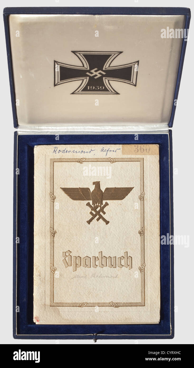 Reichsmarschall Hermann Göring,a cased bank savings book,Deutsche Bank Berlin Issued to the son(born in 1941)of a killed JU-88 bombardier. Bestowed 'Kriegsweihnachten 1941'(Christmas 1941),numbered '2154'. Cardboard cover with gold-stamped Reich Marshal Eagle,prefaced by Hitler and Göring,with entries for 1,000 RM and for accrued interest in 1942. In the rare blue case(slightly knocked)with gold-stamped Luftwaffe eagle on the cover and an Iron Cross of 1939 inside. Velvet and silk liner. A rare,complete set,historic,historical,1930s,20th century,,Additional-Rights-Clearences-Not Available Stock Photo